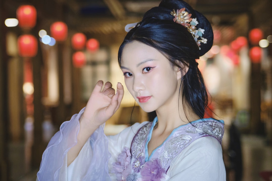 a-woman-in-a-traditional-chinese-dress-poses-for-a-picture-eejlk2rkhoi
